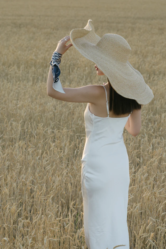 Woman in a white sleeveless dress in a field