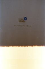 A primarily beige and dark brown image with a symbol in the center indicating image upload, featuring a small icon of a picture with a plus sign surrounded by text reading 'Drop your images here or Browse'. The bottom portion has a light leak effect.
