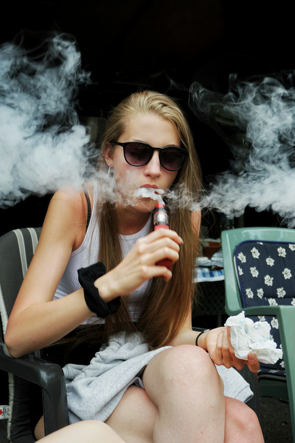 woman in black tank top smoking cigarette