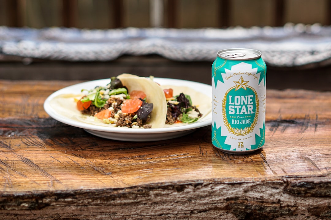 green and white labeled can, Plate of beef tacos on flour tortillas with a cold Lone Star Rio Jade beer on top of a rust