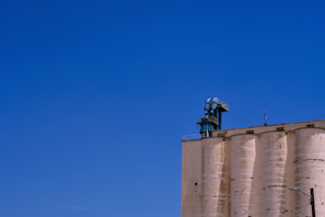 Finished industrial structure standing tall against a clear blue sky