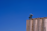 Close-up of a modern industrial silo under a clear blue sky.