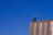 Close-up of a modern industrial silo under a clear blue sky.