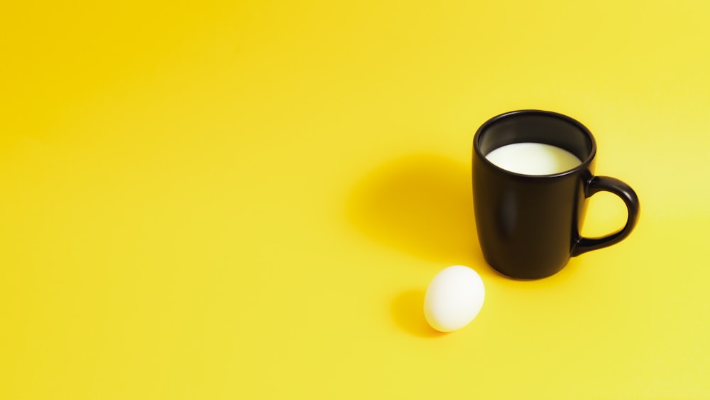 black ceramic mug on yellow surface