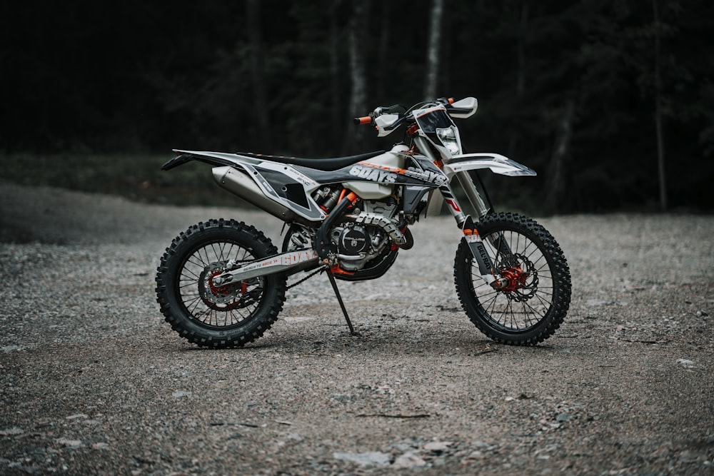 black and red motocross dirt bike on road during daytime