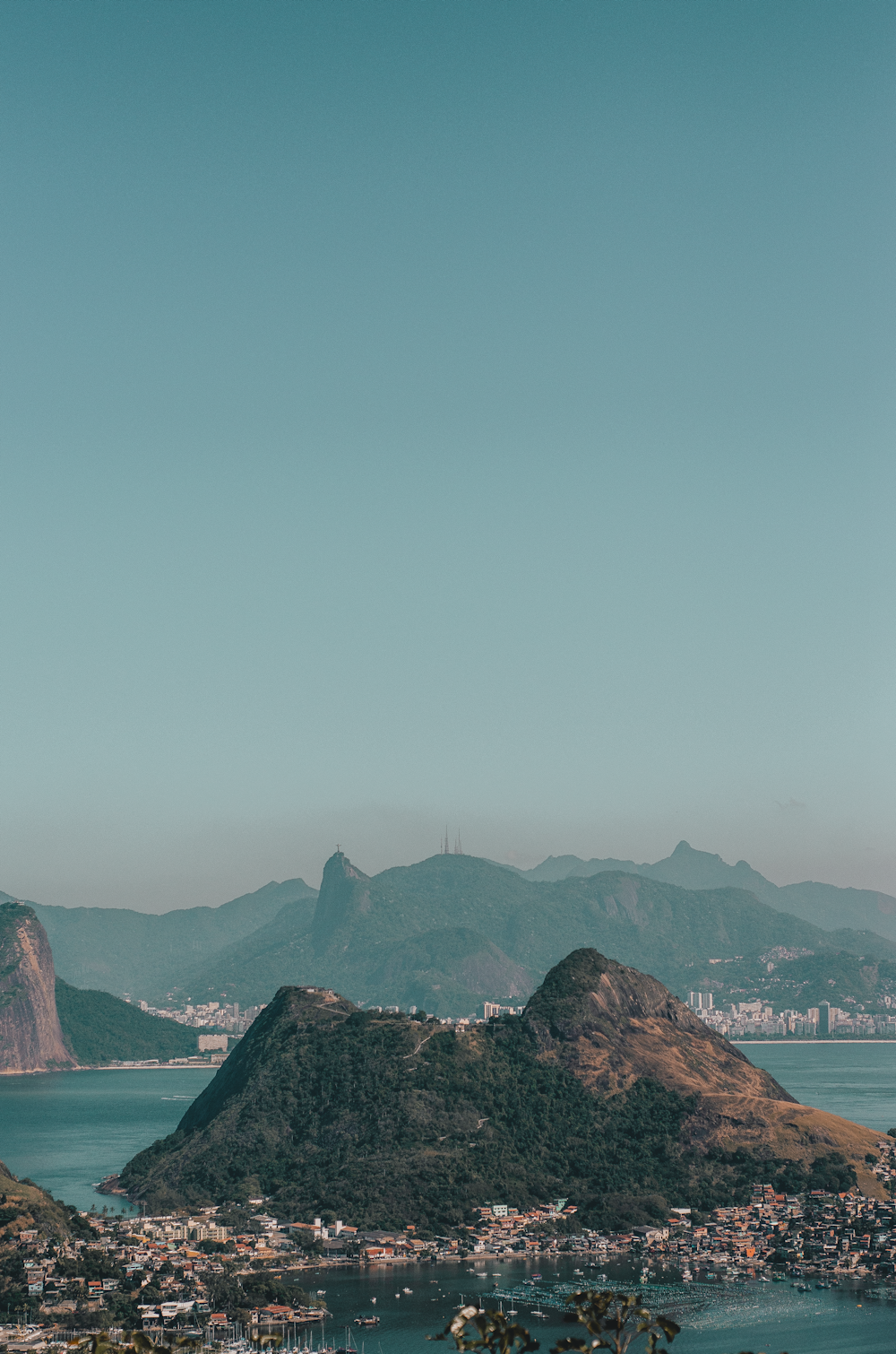 brown rock formation on body of water during daytime