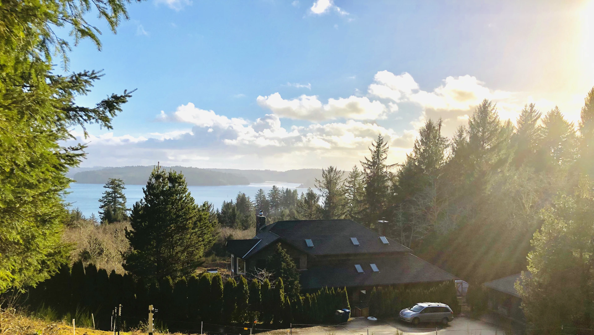 A serene view of Mila House surrounded by lush greenery and soft morning light.