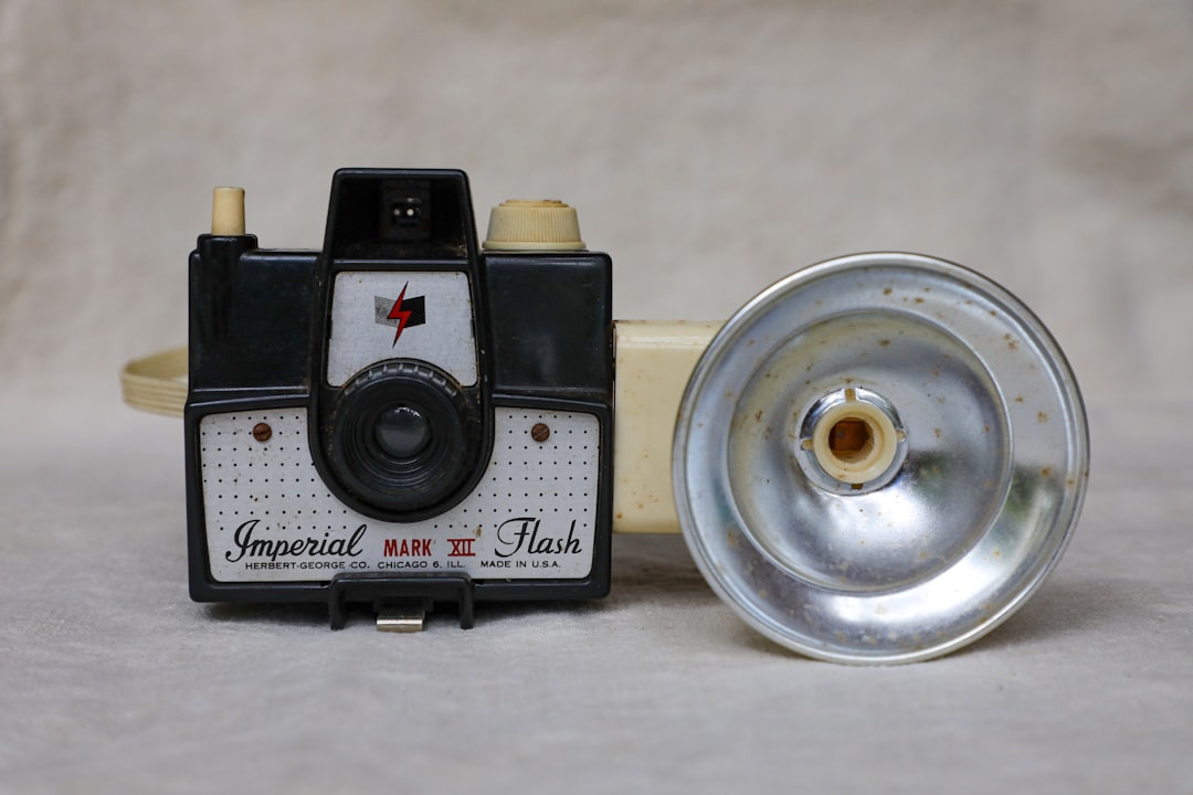 black and silver camera on white table