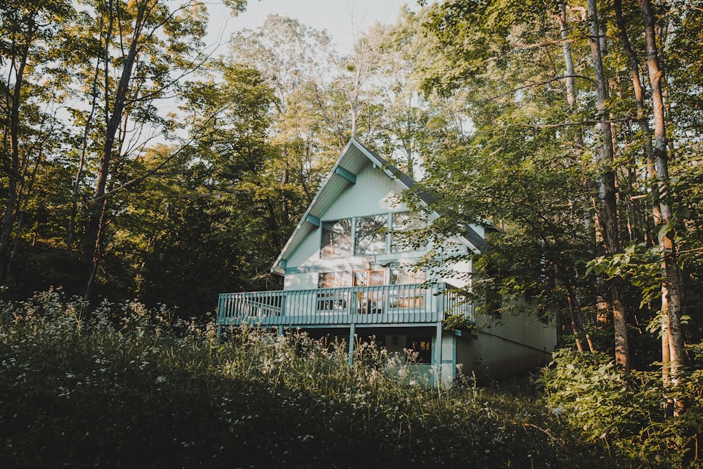 white wooden house near green trees during daytime