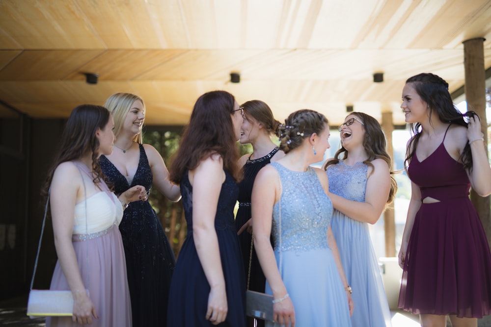 woman in white wedding gown standing beside woman in black sleeveless dress