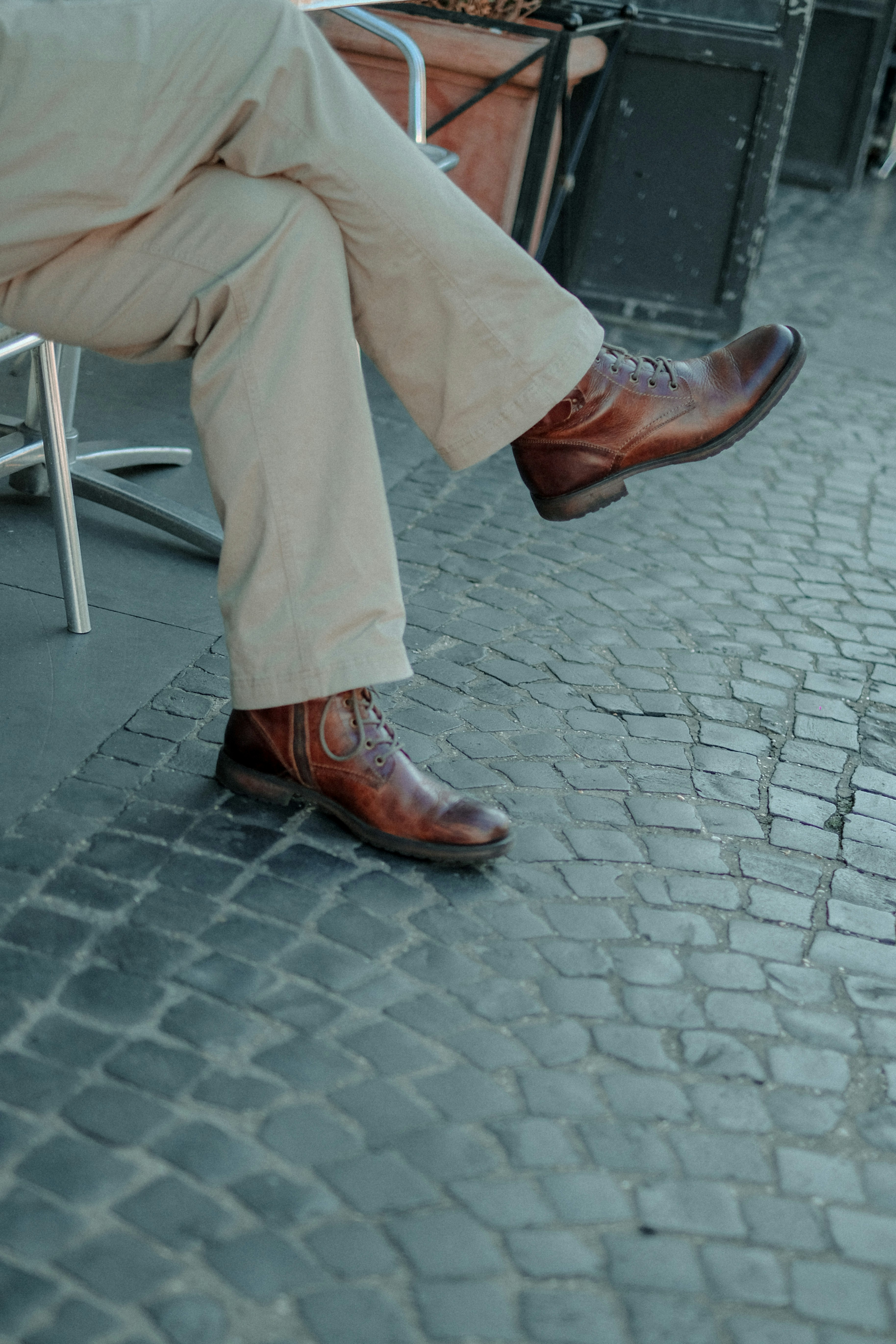 person in brown pants and brown leather shoes