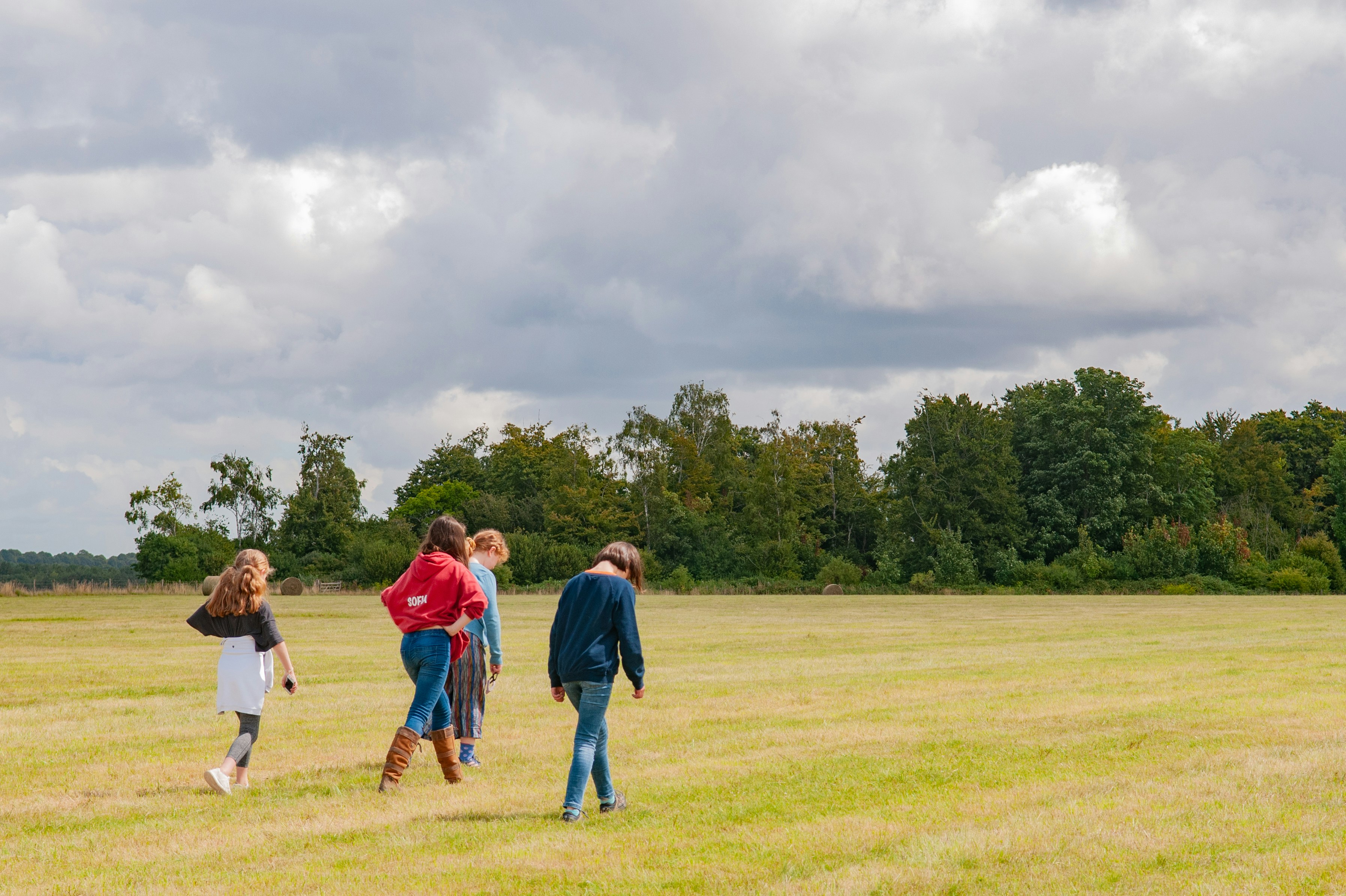 group of people standing on green grass field during daytime