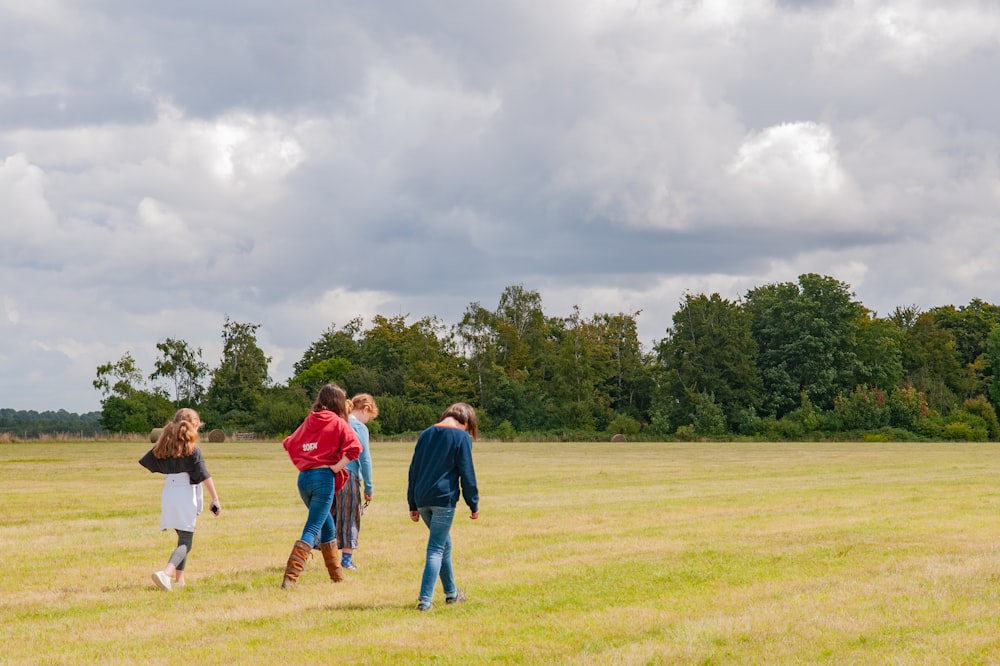 group of people standing on green grass field during daytime