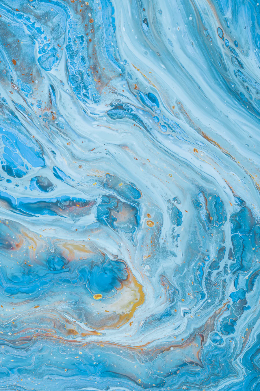 Fluid swirls of blue and warm light blending across an abstract surface