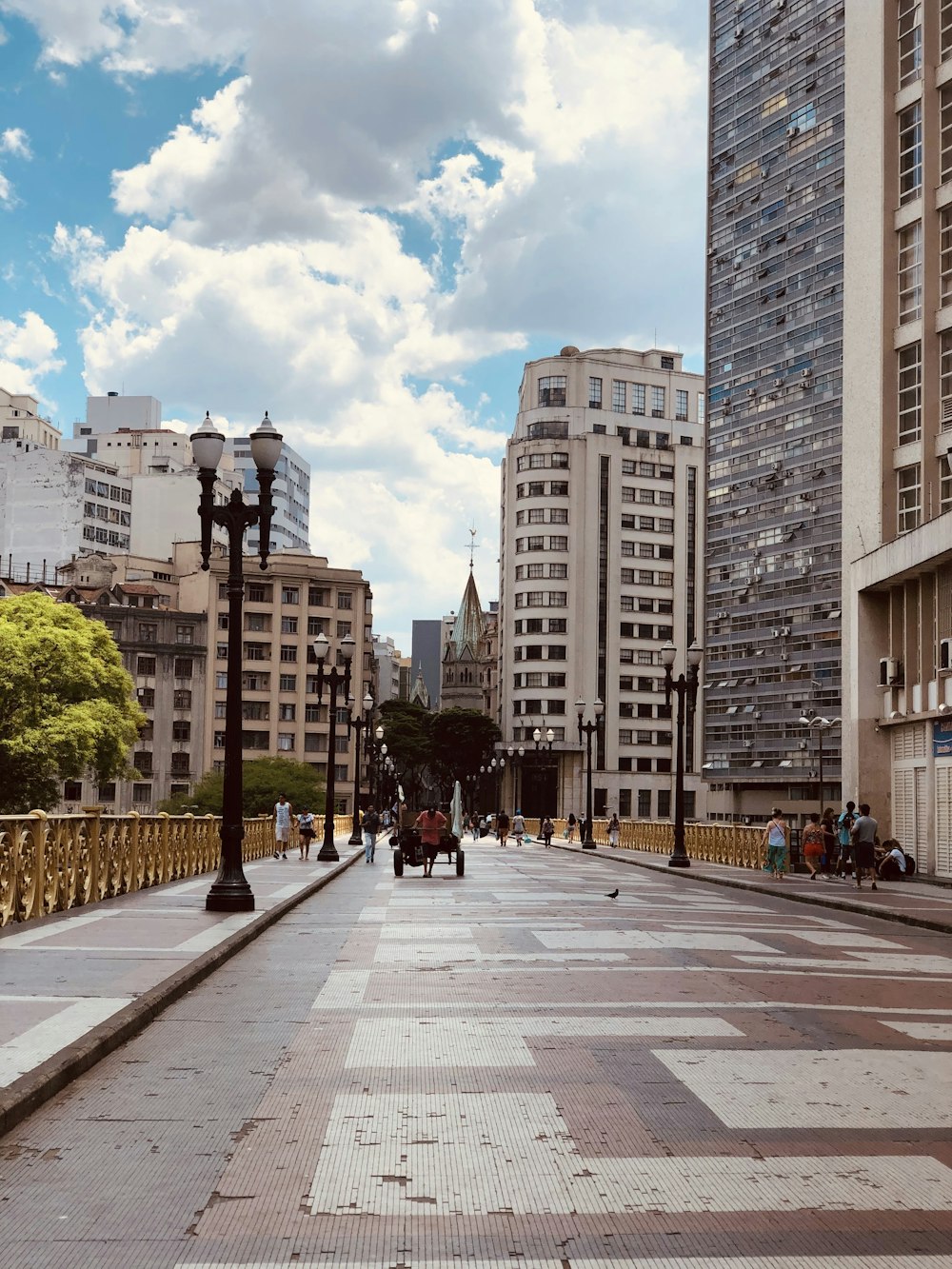 people walking on sidewalk near high rise buildings during daytime