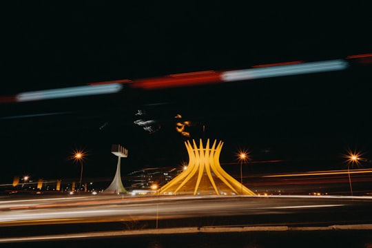 time lapse photography of cars on road during night time in Cathedral of Brasília Brasil