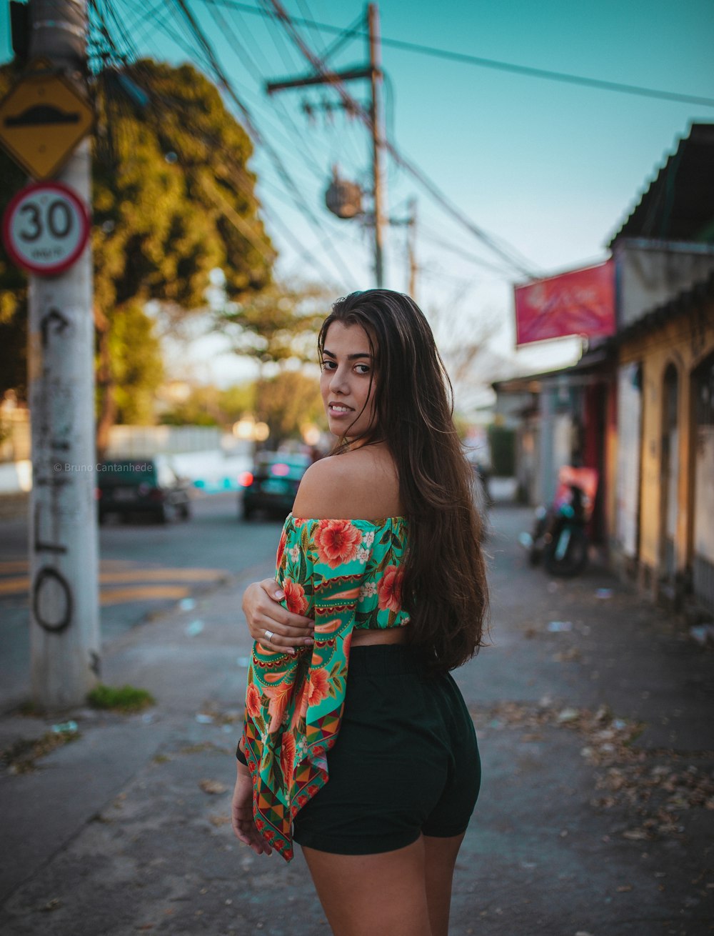 Frau in schwarzem Kleid mit rot-weißer Blumenröhre