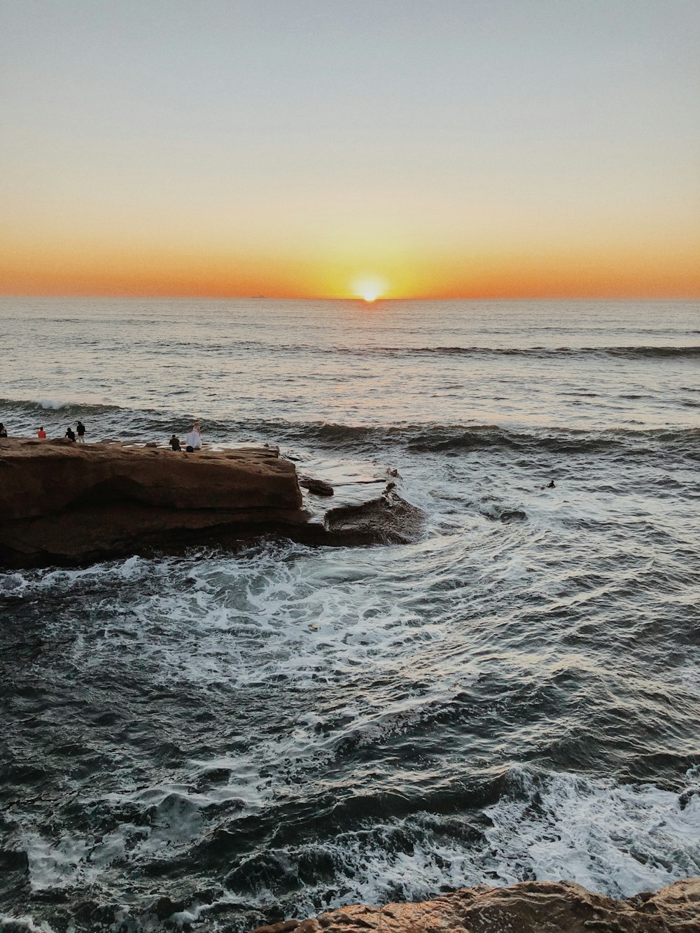 people on beach during sunset