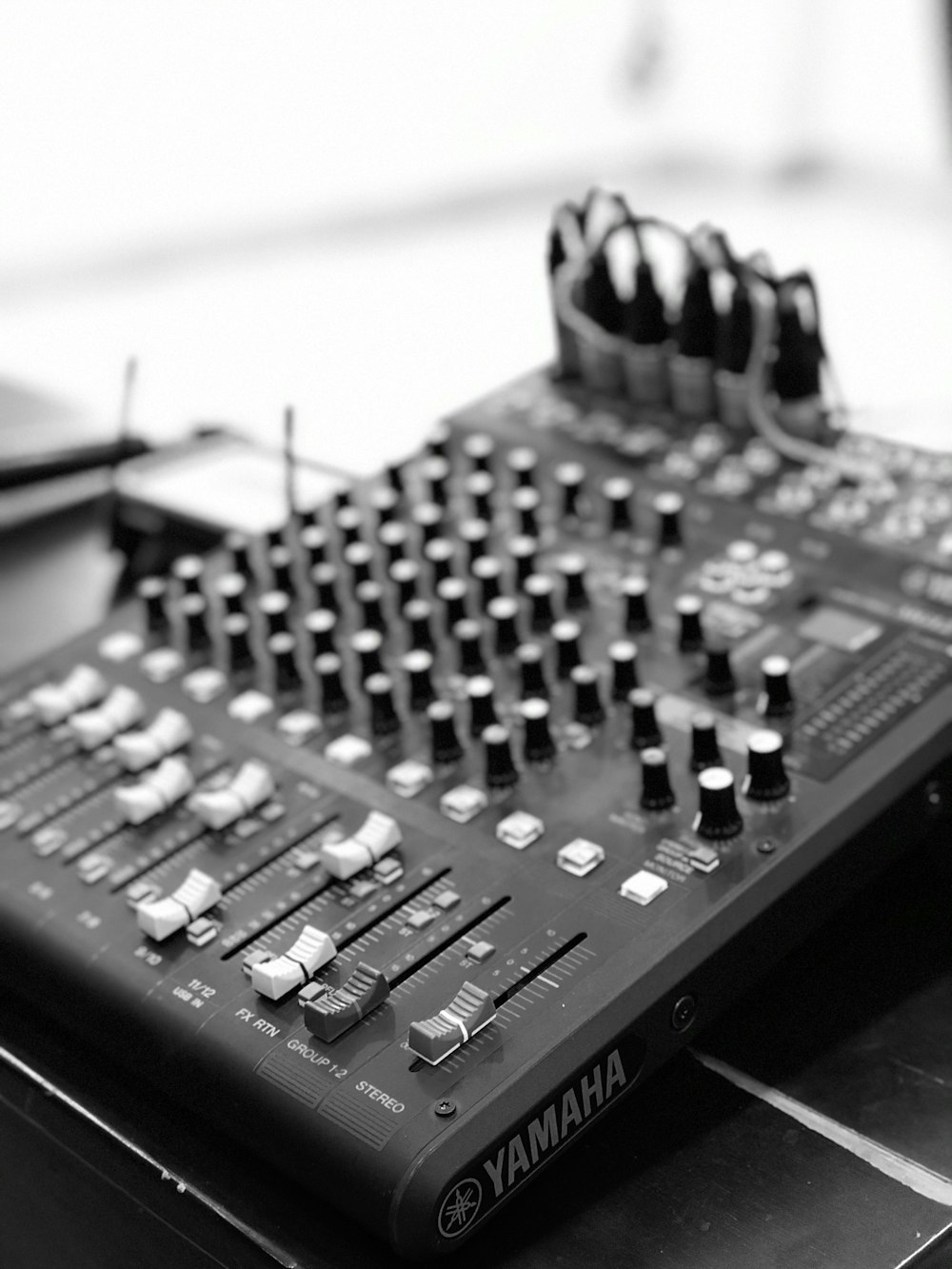 black audio mixer on white table