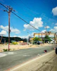 A panoramic view of a massive European highway construction site with heavy machinery in action under a clear sky.
