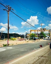 Industrial machinery operating on a busy construction site under clear skies.