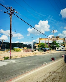Industrial machinery operating on a busy construction site under clear skies.