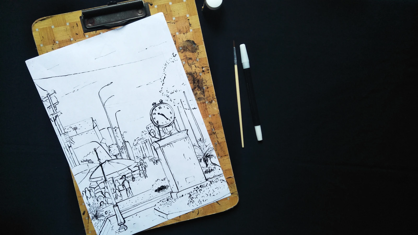 Pen sketch of a street scene on a clipboard