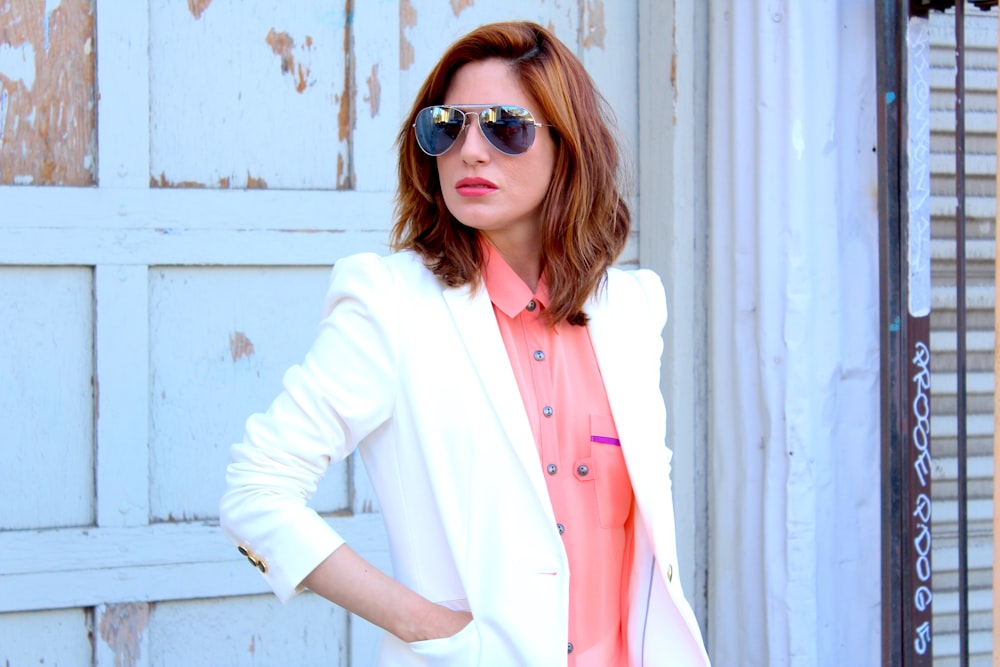 woman in white blazer wearing brown sunglasses