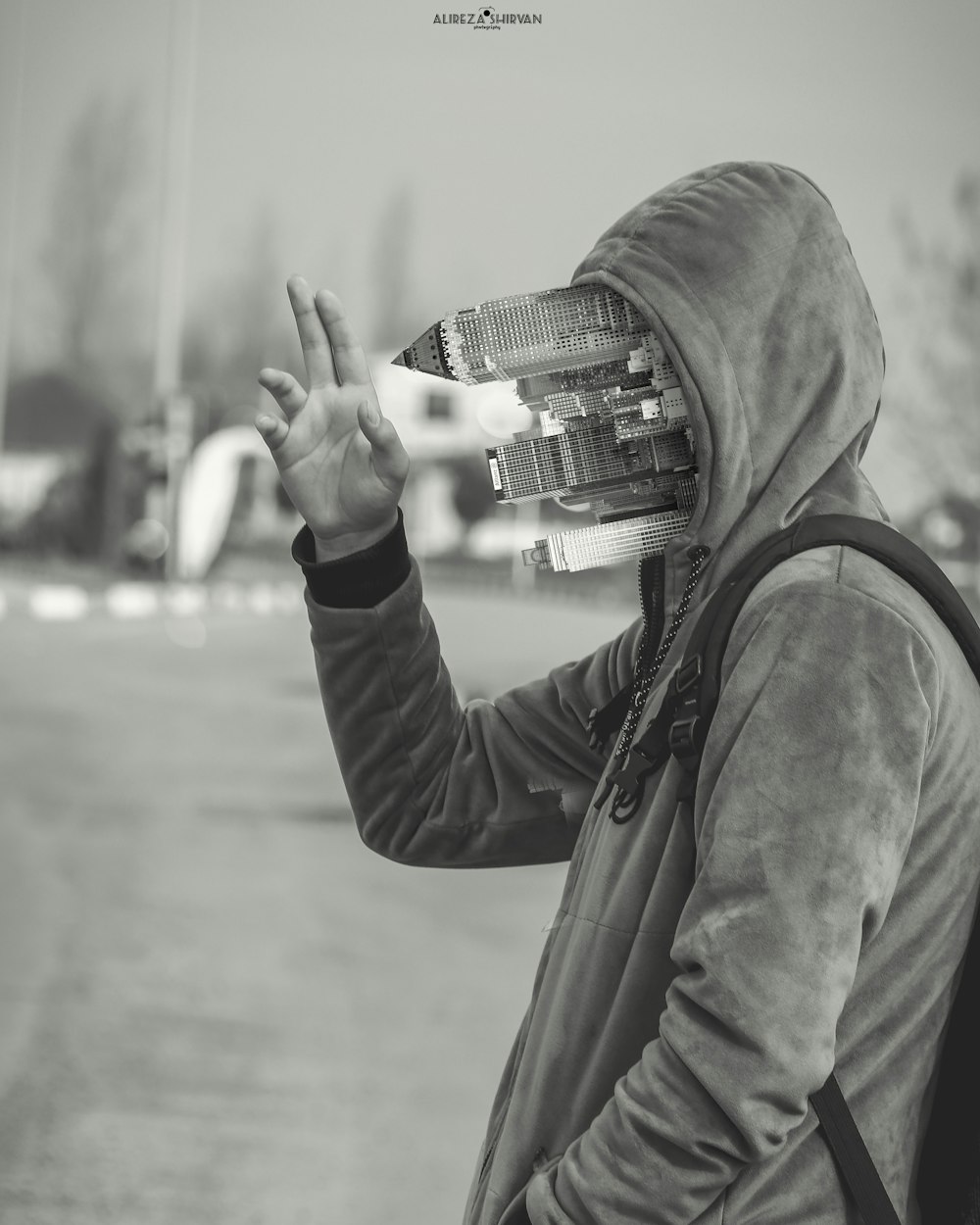 person in black hoodie holding camera