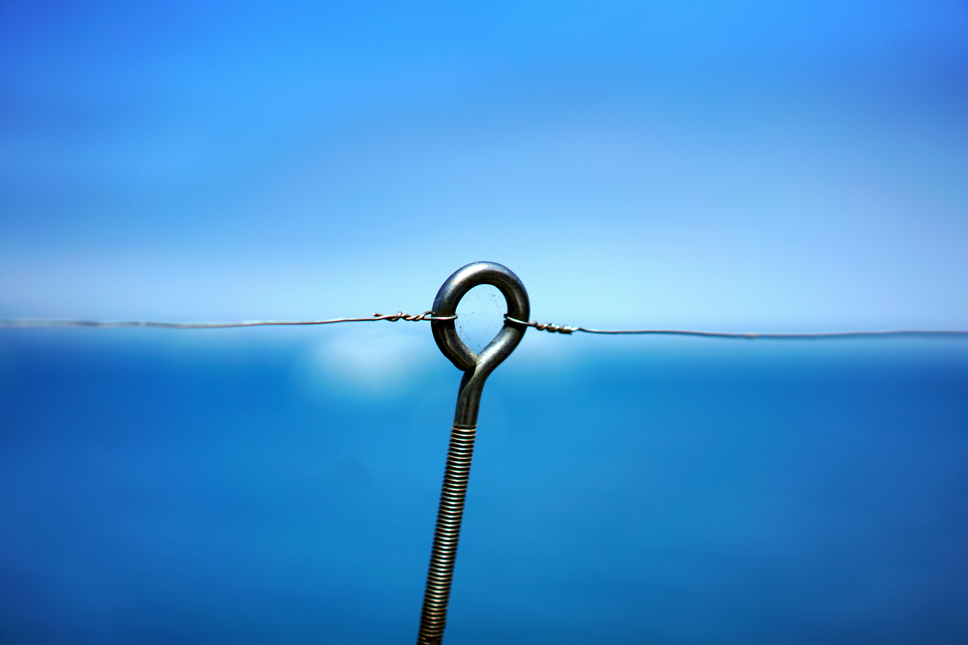 grey metal chain on blue body of water
