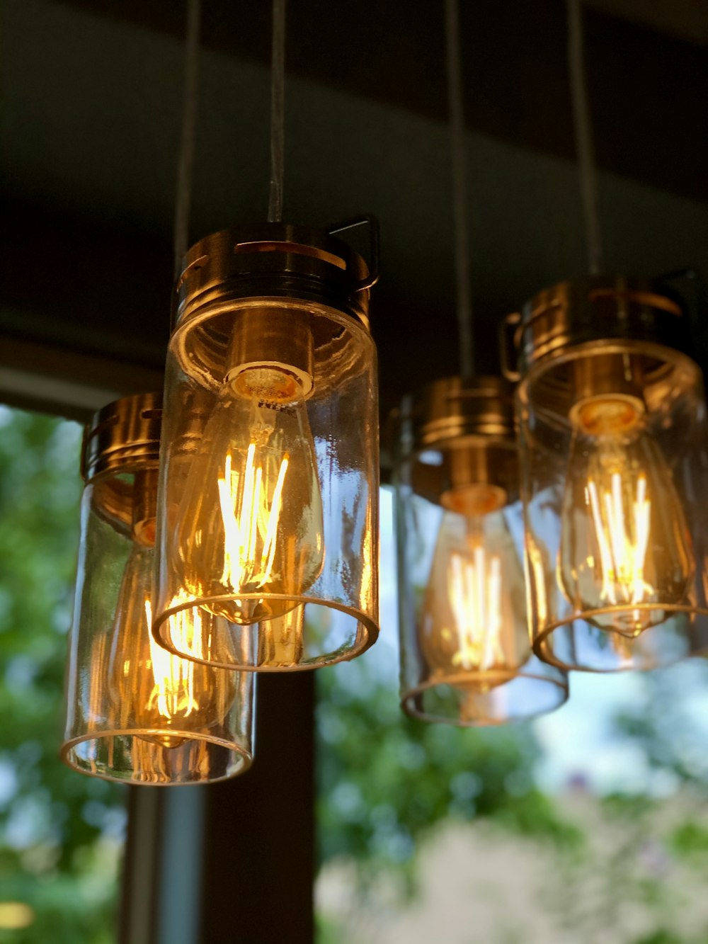 selective focus photography of three lighted candle lanterns