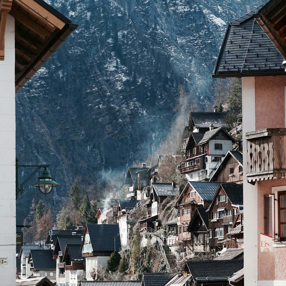 brown and white concrete buildings near mountain during daytime