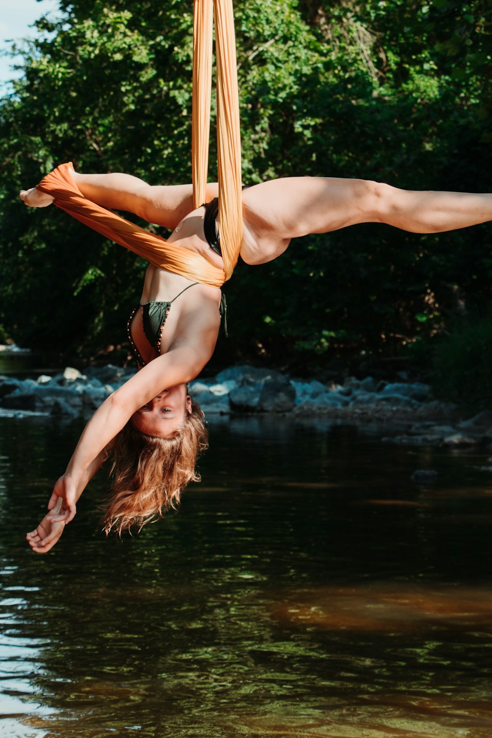 woman in black bikini lying on hammock