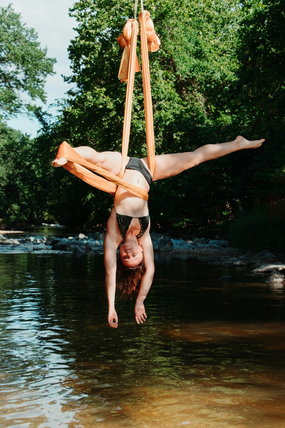 woman in black bikini lying on hammock