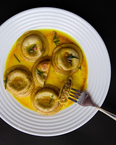Handmade ravioli filled with ricotta and spinach, topped with sage butter sauce
