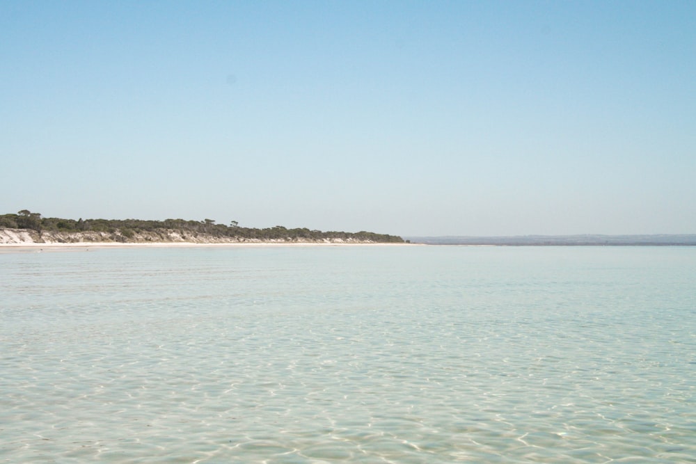 body of water under blue sky during daytime