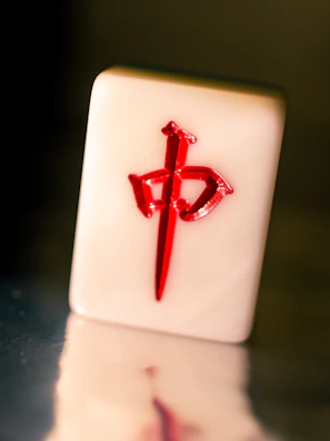 Close-up of a golden-hued mahjong mat with delicate floral patterns and a soft sheen.