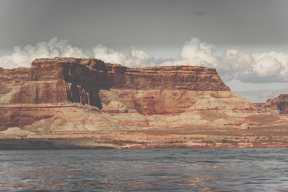 brown rock formation near body of water during daytime