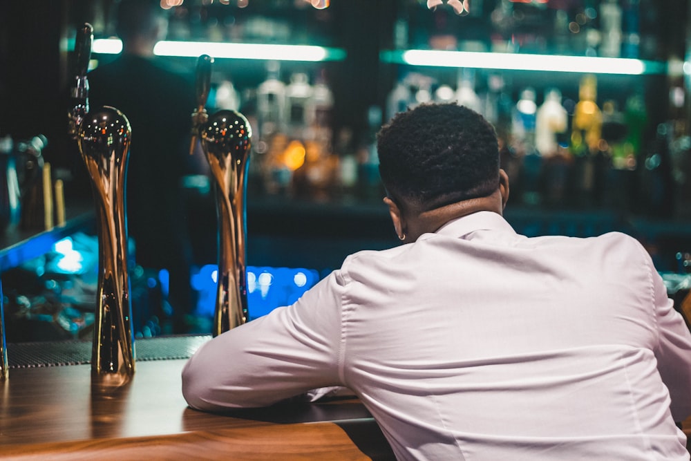 man in white shirt sitting at the table