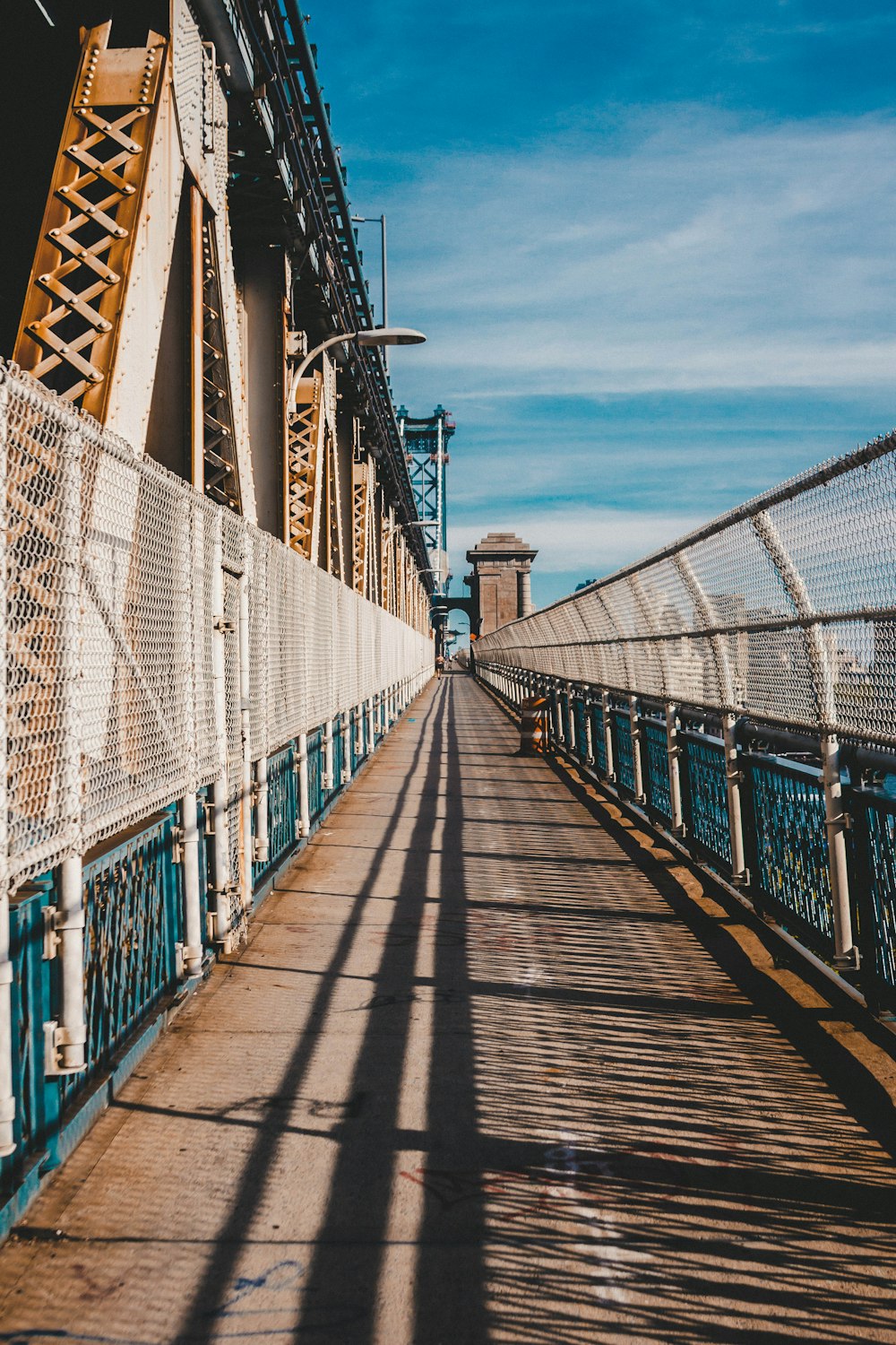 brown wooden bridge under blue sky during daytime