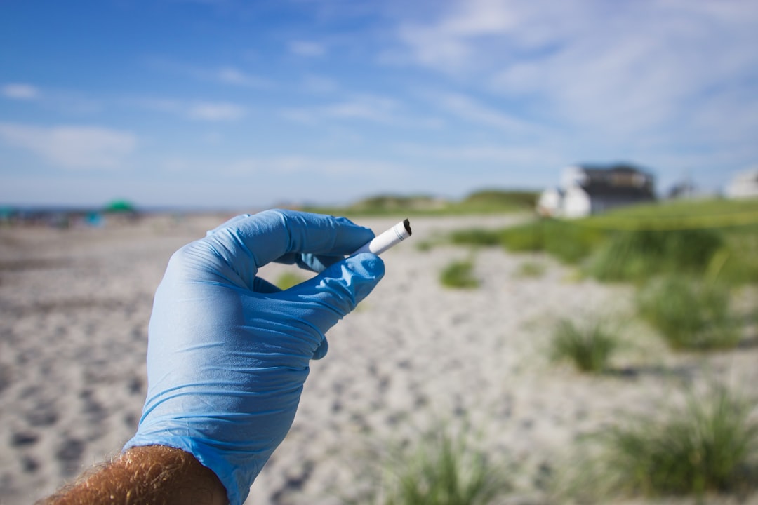 A plastic cigarette butt found during a beach cleanup in Hampton Beach, New Hampshire. During the summer, seasonal beaches are overrun with visitors, and we find overwhelming amounts of single use plastics littered across the sand. You can help by leaving the beach cleaner than you found it, and making small changes to your everyday life. Respect the ocean. Follow on Instagram @wildlife_by_yuri, and find more free plastic pollution photos at: https://www.wildlifebyyuri.com/free-ocean-photography