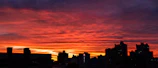 A vibrant sunset view from a luxury hotel balcony.