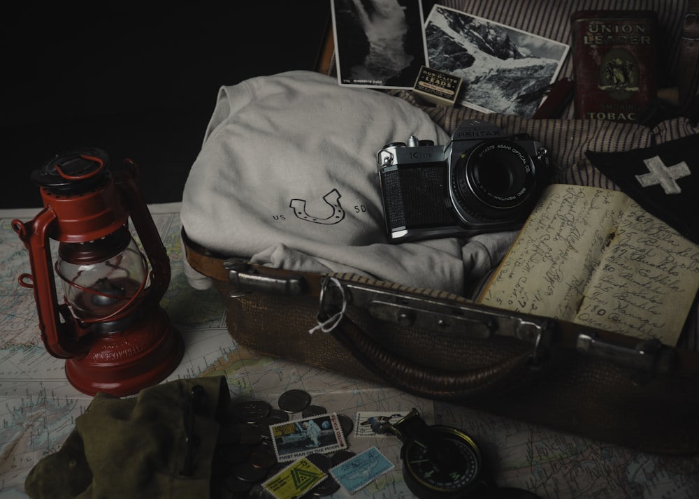 black and silver camera on brown leather bag