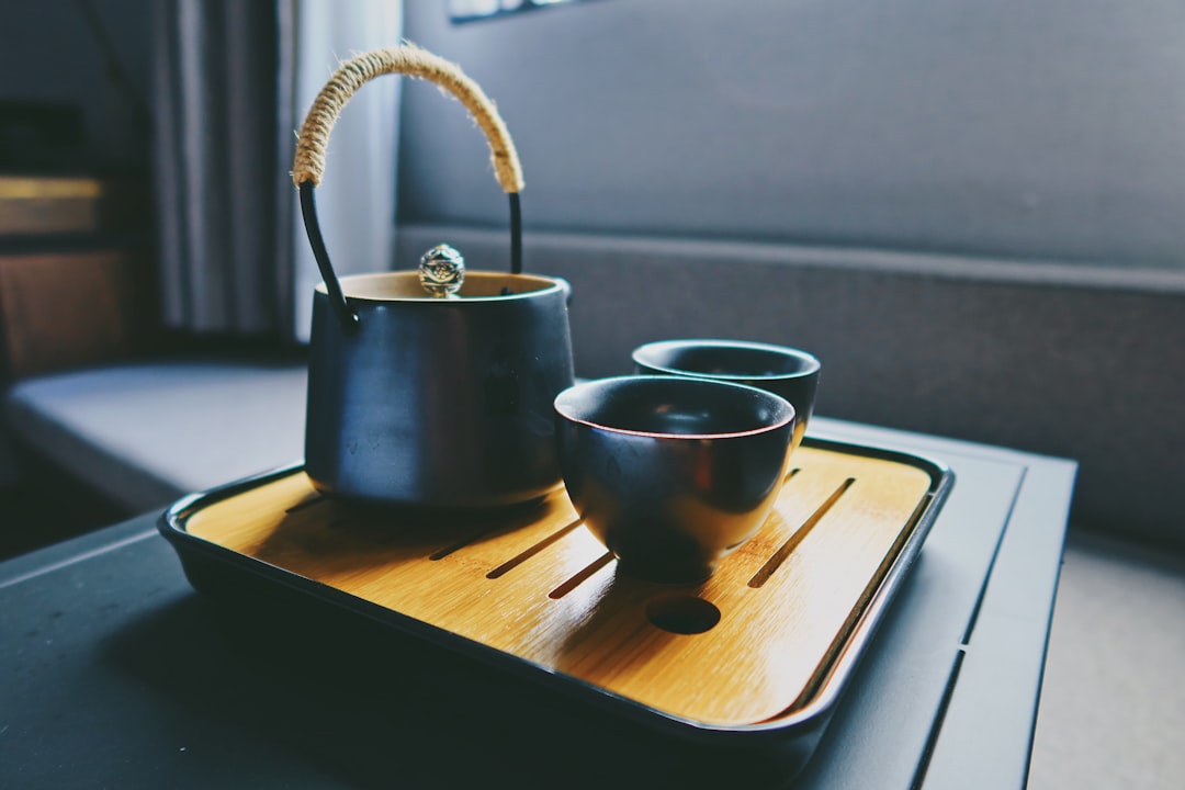 black ceramic mug on brown wooden tray