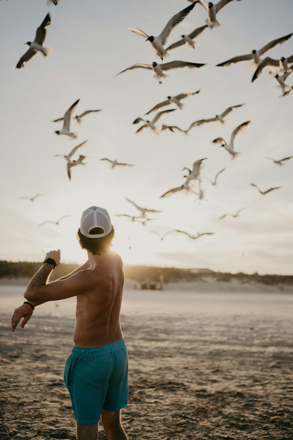 boy in blue shorts standing on beach during daytime