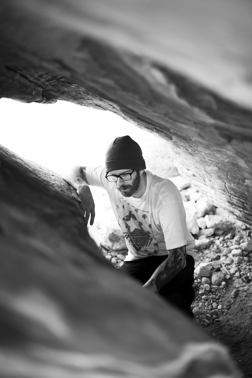 grayscale photo of man in white long sleeve shirt and black pants