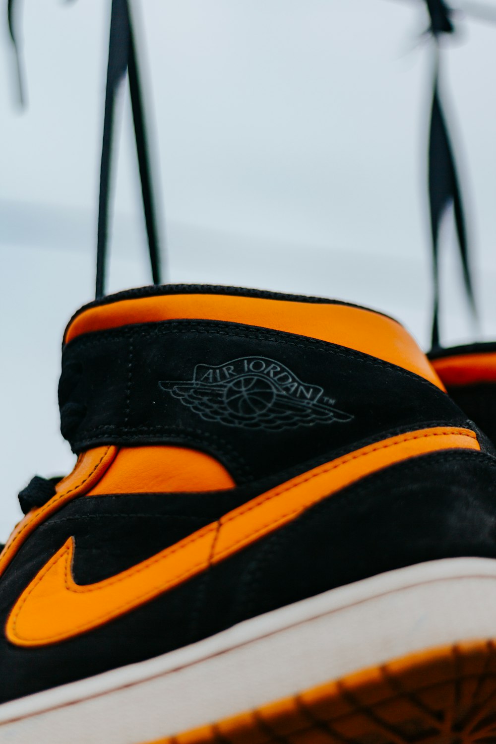 black orange and white nike high top sneakers