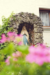 A vibrant springtime photo of young pilgrims praying joyfully at a Marian shrine.