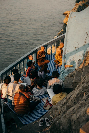 A serene Vietnamese Buddhist community gathering in a peaceful temple garden at sunset