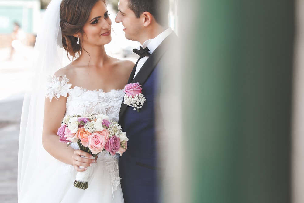 a bride and groom are posing for a picture